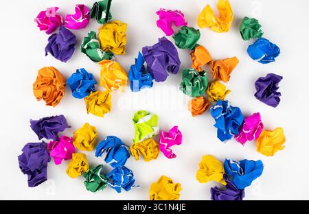 scattered colorful crumpled paper balls on white background Stock Photo