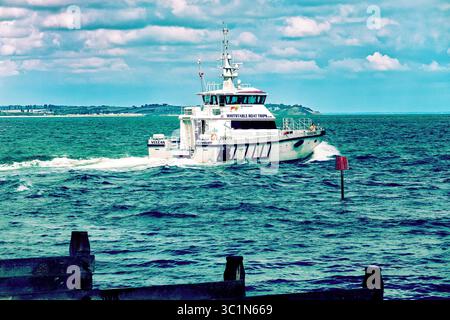 Motor boat Vulcan of the Whitstable Boat Trips company leaving Whitstable harbour. Stock Photo