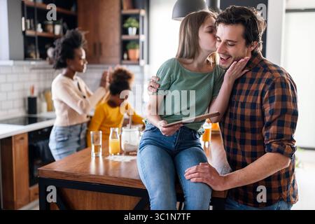 Happy multiethnic family having fun while cooking and using digital tablet at home Stock Photo