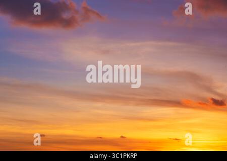 Dramatic red, orange, and yellow clouds in a real fiery sky at sunset. High resolution photography for sky replacement, background or graphic design Stock Photo