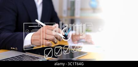 Permit approval digital concept with document icon, checkmark, and modern interface. Businessman in suit using digital pen for online approval applica Stock Photo