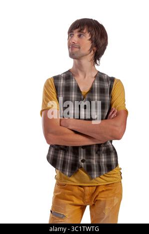 A young man poses confidently with a smile, wearing a plaid vest over a yellow shirt. Stock Photo