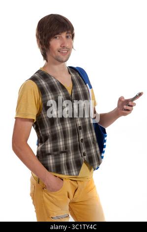 A casually dressed young man holds a smartphone, smiling confidently. Stock Photo