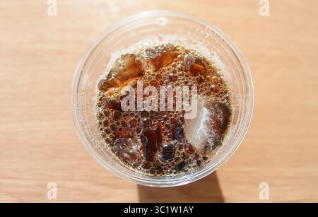 Refreshing Glass of Cold Iced Cola with Effervescent Bubbles in Bright Lighting Stock Photo