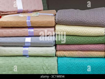 Pile of household textile towels and bedding sheets in home cupboard Stock Photo
