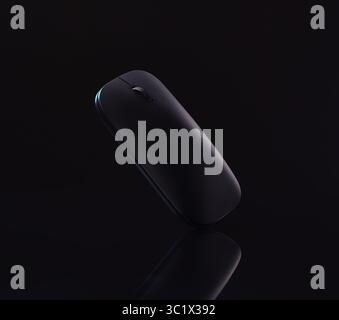A sleek, black mouse rests on a dark surface, with a mirror reflecting its form. The mouse has a minimalist design. The background is completely black Stock Photo
