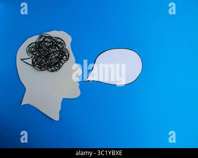 Tangled Thoughts and Blank Speech Bubble on Blue Background Stock Photo