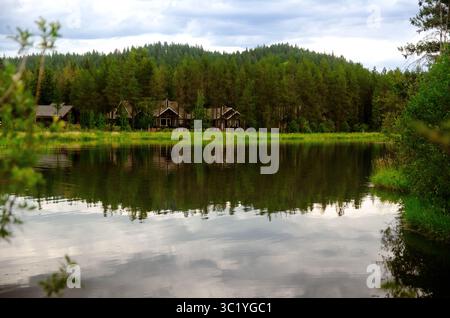 Lakeside house Nestled in Evergreen Forest Stock Photo