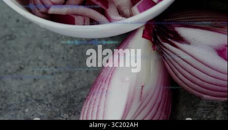 Displaying halved red onion and slices in white bowl on grey stone countertop with digital overlays Stock Photo
