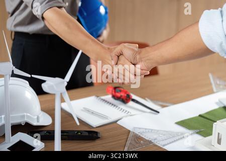 Sustainability in Architecture. Professionals collaborating on eco-friendly building design. Stock Photo