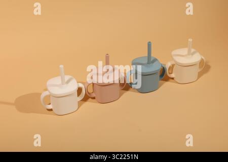 Colorful Ceramic Teapots with Lids and Straws in Pastel Tones Stock Photo