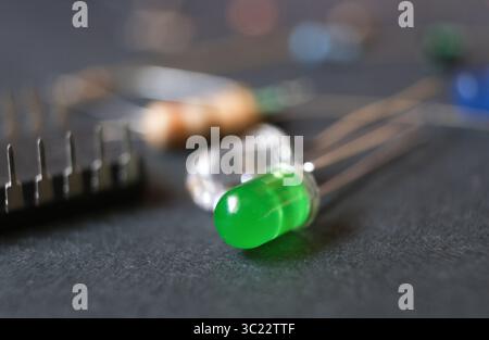 Semiconductor light and optical sources. Single-color LEDs. Focused on green color light-emitting diode. Stock Photo