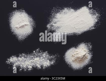 Sprinkled wheat flour splash spots on black background Stock Photo
