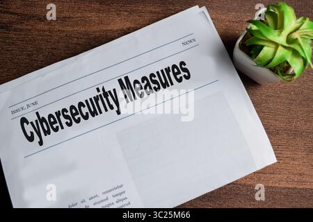 Cybersecurity measures text in headline isolated on wooden table. Newspaper concept Stock Photo