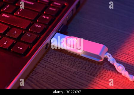Flash drive plugged into the USB port of a laptop computer Stock Photo