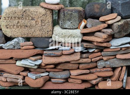 London, UK - Jul 21, 2025 - Displays of bricks and pottery shards, arranged in a wall-like structure, which are consistent with finds from mudlarking Stock Photo