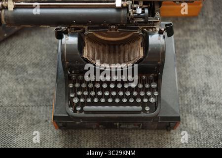 A Vintage Typewriter Displayed Beautifully on a Rustic Surface for Aesthetic Appeal Stock Photo