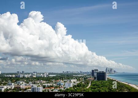 Miami Beach Florida,aerial overhead view looking north toward Bal Harbour and Sunny Isles Beach,dramatic cumulus cloud formation over skyline,rope sea Stock Photo