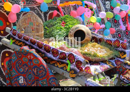 A diverse collage of vegetables and fruits on an old horse cart with a live partridge in a wooden cage. Stock Photo