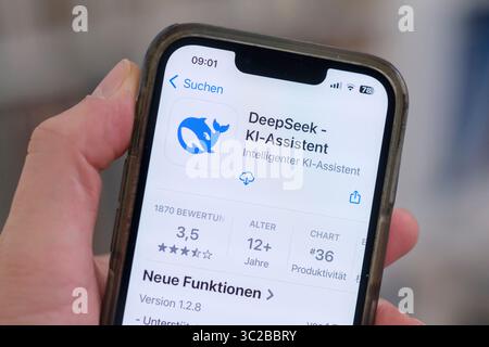 A cell phone with the Apple App Store page open shows the DeepSeek app for download. Stock Photo