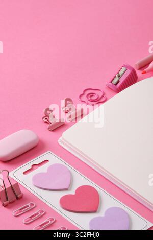 Stationery background in pink theme, open notepad sheet and office supplies. A place for your text. Stock Photo