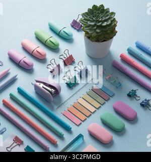 Stationery background with pastel-colored office supplies neatly arranged on a light blue background. Selective focus. Stock Photo