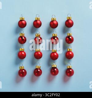 Minimalistic composition of red Christmas ornaments on a light blue background Stock Photo