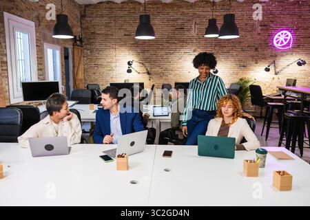 Multi ethnic team collaborating on project in modern office Stock Photo
