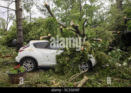 June 16, 2019 - Ellettsville, Indiana, United States - A car sits damaged, and covered with fallen trees, on W. Chafin Chapel Rd, during the aftermath..A tornado struck the area leaving a patch of damage from Greene County to Northern Monroe County destroying trees, homes, cars, and leaving a path of debris and live power lines on the ground in its wake. (Credit Image: © Jeremy Hogan/SOPA Images via ZUMA Wire) Stock Photo