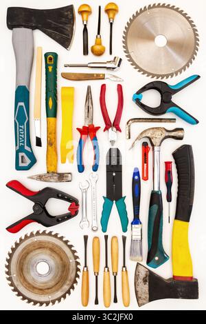 Flat lay of new and used hand tools on white background. Large collection of various tools and bits arranged on white. Stock Photo
