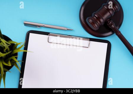 Top view of blank clip board and gavel Stock Photo