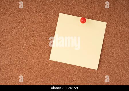 Blank sticky note on a cork board Stock Photo