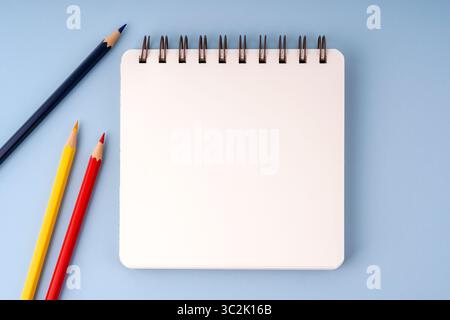 Top view of blank notepad with colorful pencils template Stock Photo