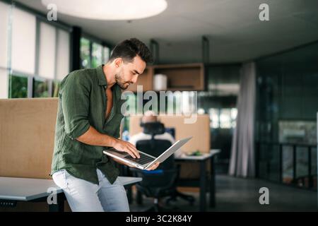 Software engineer using laptop computer with global network connection, Technology, innovation Stock Photo