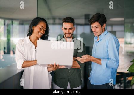 Mixed team of software engineers brainstorming ideas. Diverse app developers collaborating as group Stock Photo