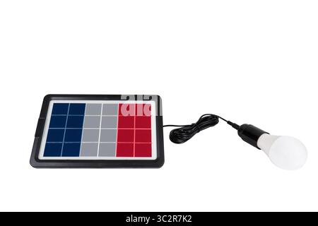A solar panel with a French flag on a white background is connected to a white LED light bulb, illustrating sustainable energy and green solutions Stock Photo