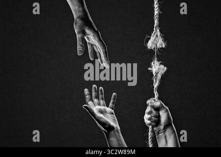 Hold on to Frayed Rope About to Break Asking for Help Each Other Against Textured Black Background Stock Photo