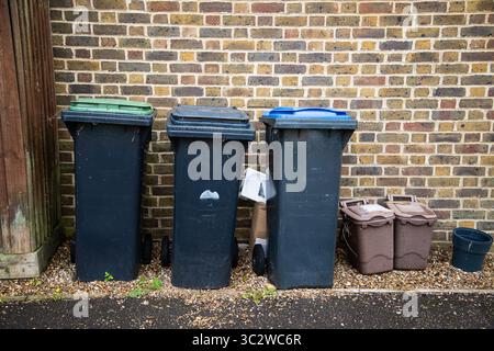 Waste bins - lined up in a row Stock Photo - Alamy
