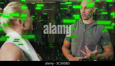 Gesturing trainer and client discussing workout plan in gym, with towel, hoodie and code overlay Stock Photo