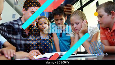 Pointing checked-shirt teacher guiding children reading at school table with open book, copy space Stock Photo