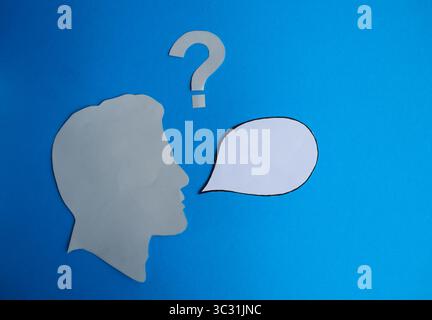 Human Head Silhouette with Blank Speech Bubble and Question Mark Stock Photo