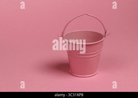 Empty mini bucket on a pink pastel background. Minimalism. Trend color concept Stock Photo