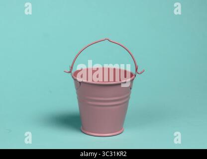 Pink empty mini bucket on blue pastel background. Minimalism. Trend color concept Stock Photo