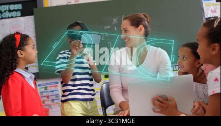 Guiding teacher using laptop and projecting hologram with students holding VR headset at classroom Stock Photo