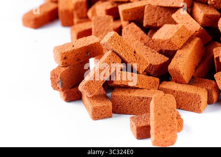 Pile of toy house bricks close up with text space on a white background Stock Photo