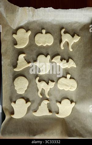 Fresh baked halloween cookie shapes on brown parchment paper Stock Photo