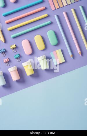 Stationery banner in green, yellow, pink and blue pastel colors on light purple and blue background. Space for your text. Stock Photo