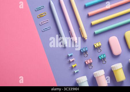 Stationery banner in green, yellow, pink and blue pastel colors on light purple and pink background. Space for your text. Stock Photo