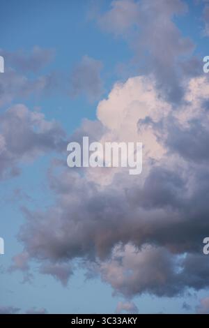 Fluffy Clouds at Dusk in the Summer Sky Stock Photo