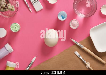 Preparing for Easter celebrations. Coloring Easter eggs with gouache. Clean light colored eggshells for your design. Stock Photo
